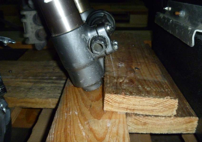 Fork stop on treated wood crate. Much quicker and easier than bolting axle through wood.